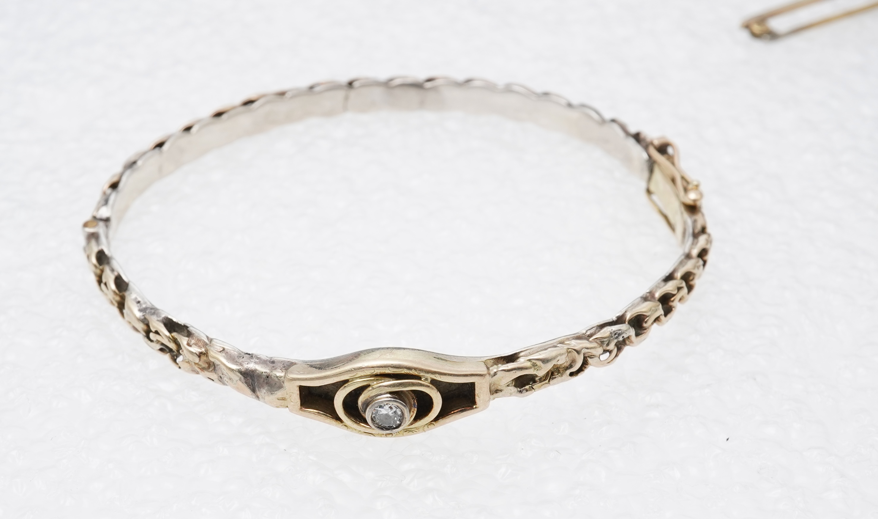 A collection of jewels and accessories, comprising: an onyx and diamond bar brooch, mounted in gold; a bangle set with a circular-cut diamond weighing approximately 0.07 carats, inner circumference approximately 17cm, st